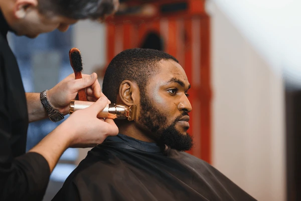 Professional black man with stylish buzz cut fade, grooming, men's haircut