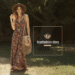 A woman wearing a flowing floral maxi dress and a wide-brim hat, embodying the boho fashion style.