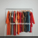A vibrant collection of fashion 21 dresses in various styles and colors hanging on a clothing rack.