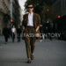 A stylish person confidently walking down a city street, wearing a chic, well-fitting outfit with statement accessories.