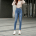 A stylish woman wearing a popular pair of high-waisted Fashion Nova skinny jeans, posing confidently against an urban background.