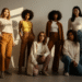 A diverse group of confident models posing together, showcasing trendy outfits that represent the Fashion Nova brand.