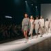 A diverse group of models walking the runway at Fashion Week DTI, showcasing innovative designs from an emerging fashion brand.