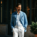 A stylishly dressed man in an unstructured blue blazer and white trousers, embodying classic Italian men's fashion.