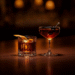 Two classic cocktails side by side showing Old Fashioned and Manhattan with their distinct garnishes and glassware