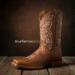 A close-up shot of a beautifully crafted brown leather overlay boot with an intricate white floral design stitched on the shaft.
