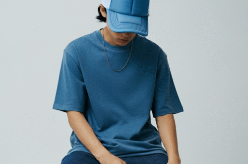 A stylish person wearing a matching Von Dutch set, including a blue trucker hat and t-shirt, against a clean, modern background.