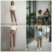 A woman wearing the stylish and versatile victoria high waisted dress pants - taupe with a white blouse in a modern office setting.
